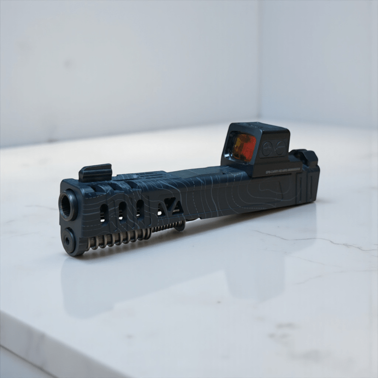 Black machined pistol slide on a light surface