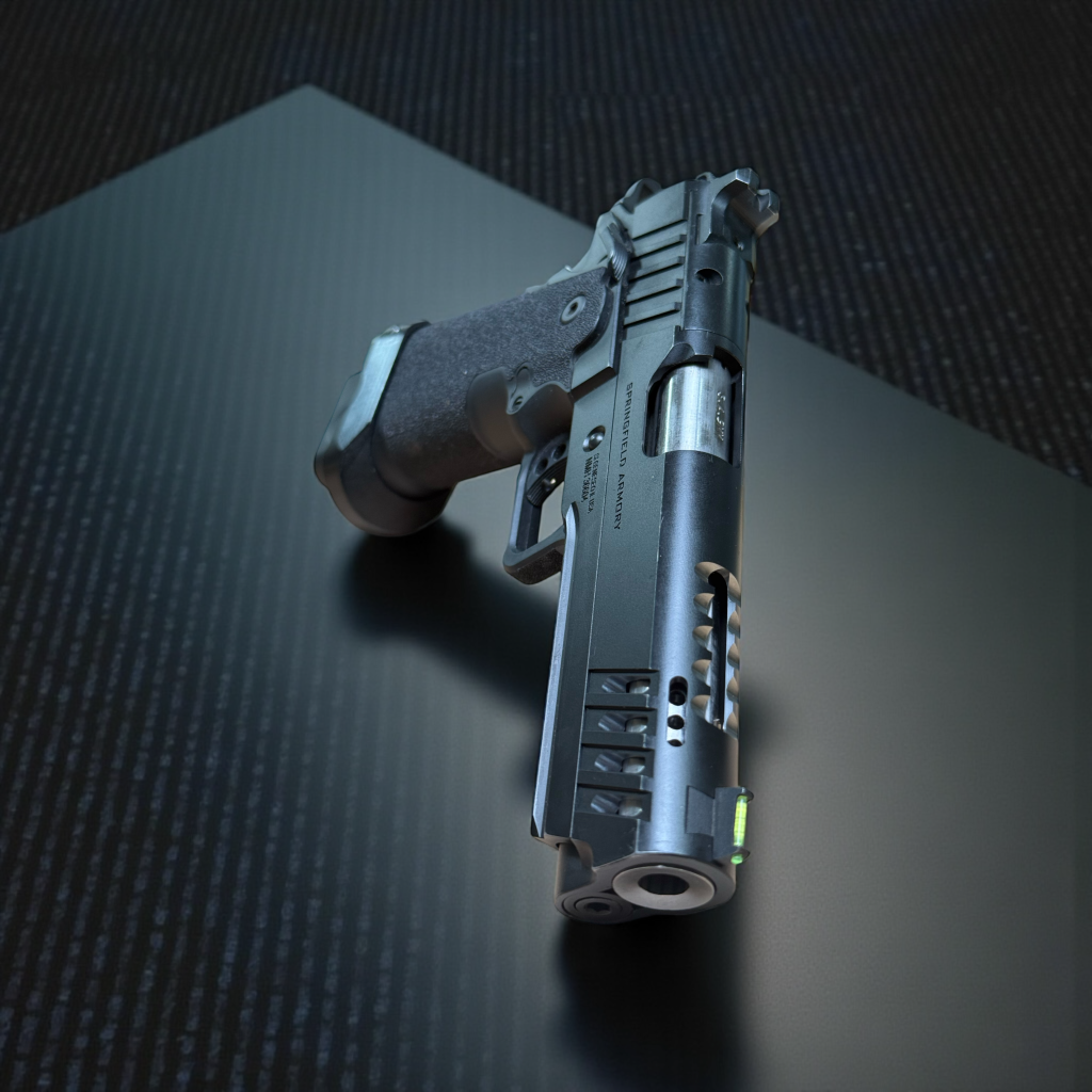 Black custom pistol photographed in a dark studio