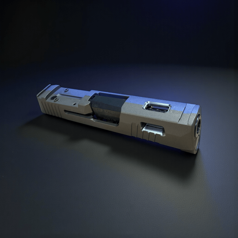 Silver machined pistol slide in a dark studio